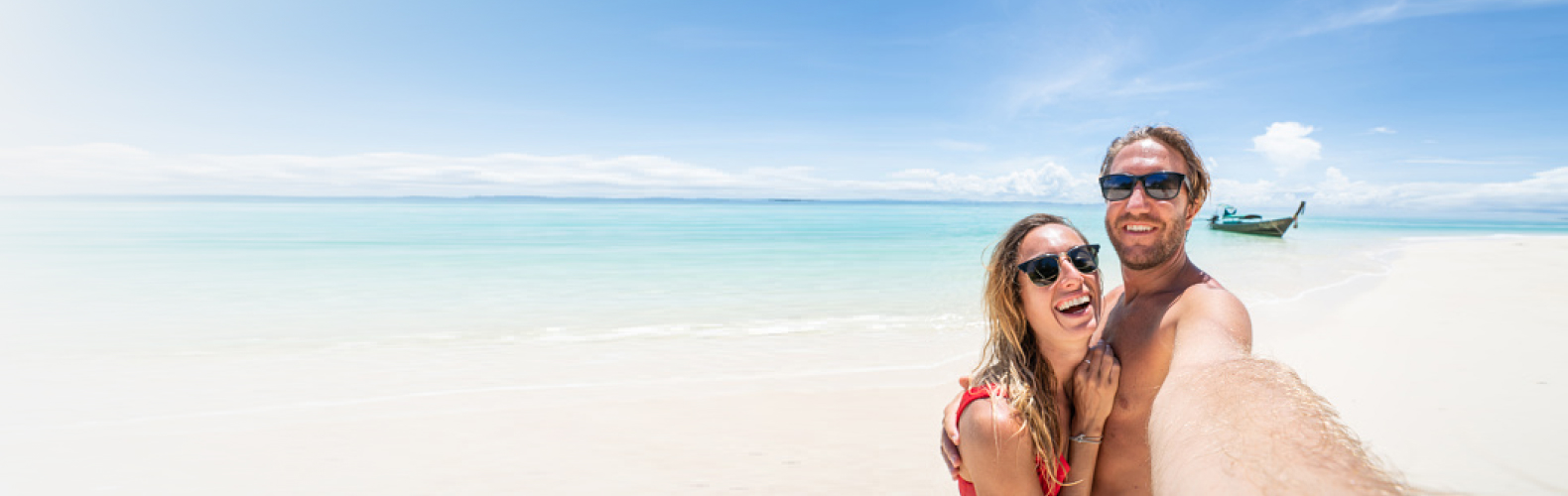 Two tourists taking a selfie on the beach with International Visitors Two tourists taking a selfie on the beach with International Visitors